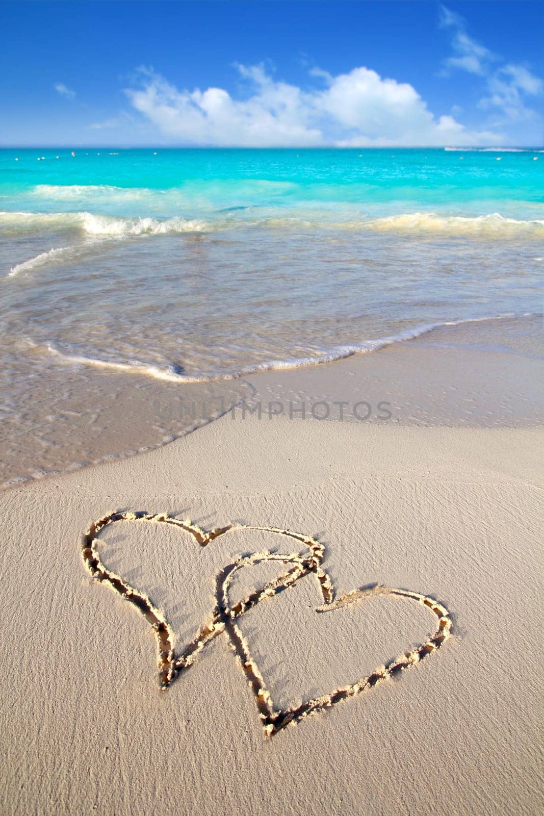 hearts in love written in Caribbean tropical beach sand