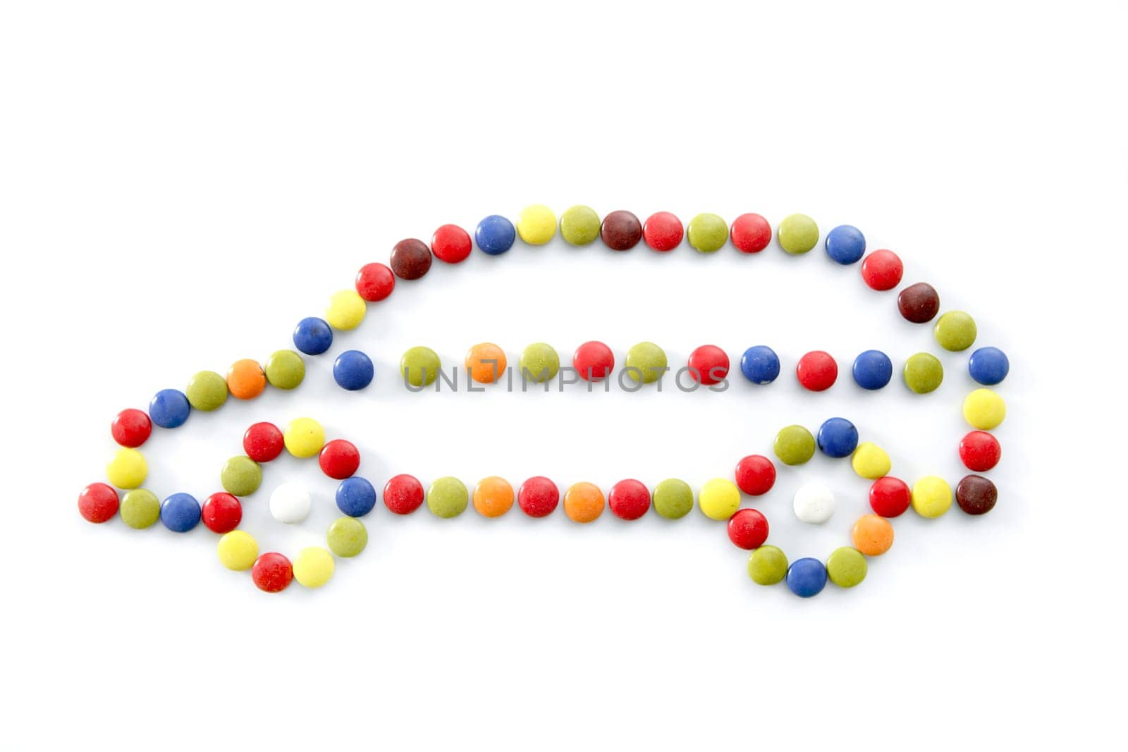 candy car made of little chocolate color sweets, isolated over white background