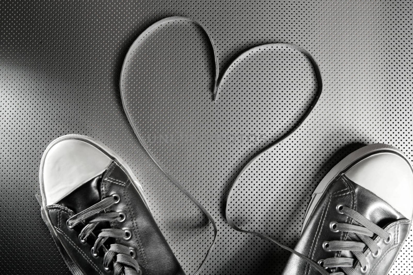 Laces of silver shoes, threads with heart valentines shape