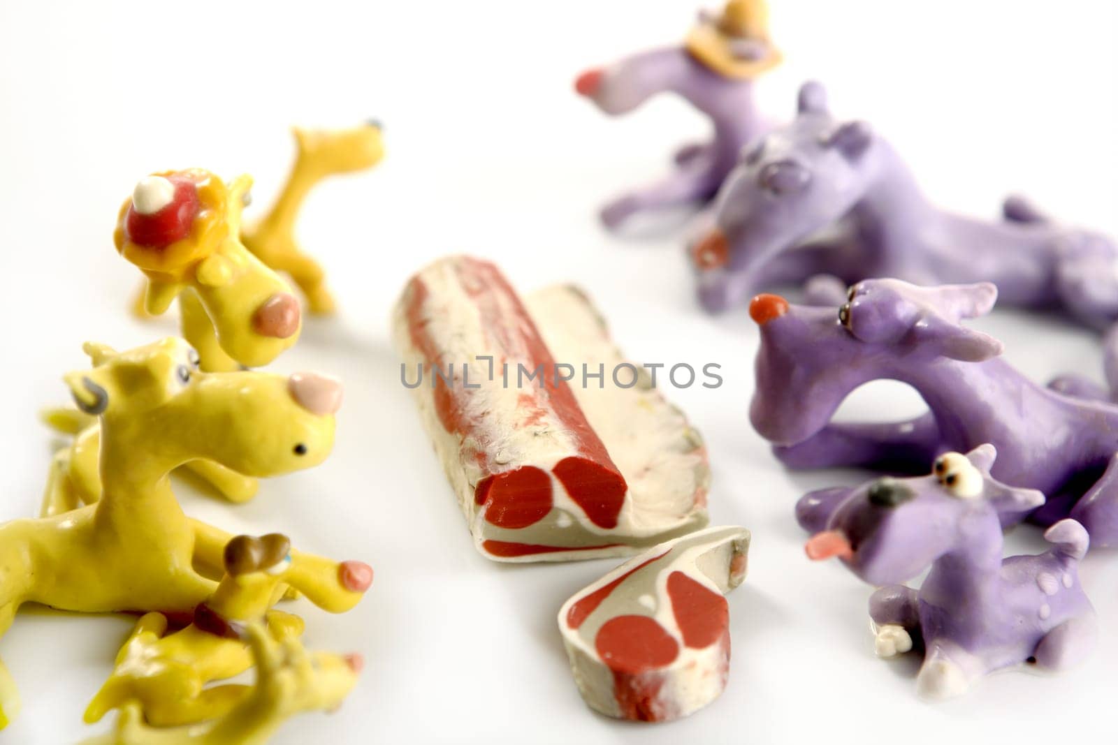 Handmade hungry plasticine dogs withy some meat to eat