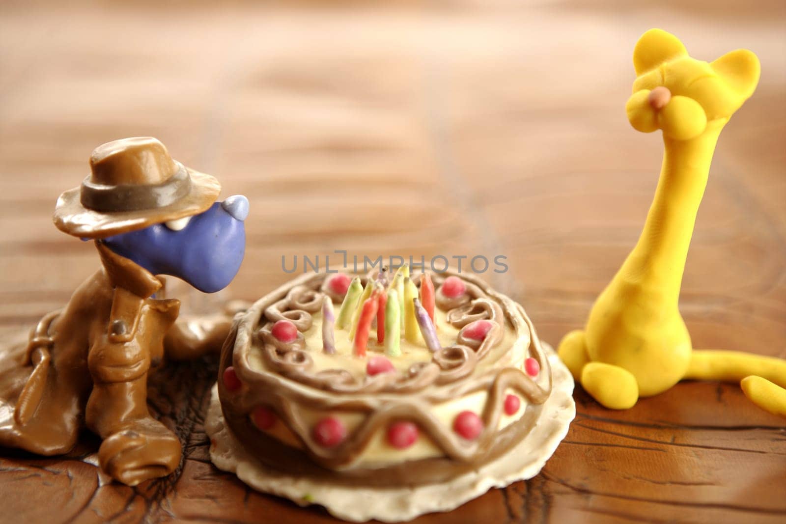 Toy plasticine happy birthday cake isolated over white background