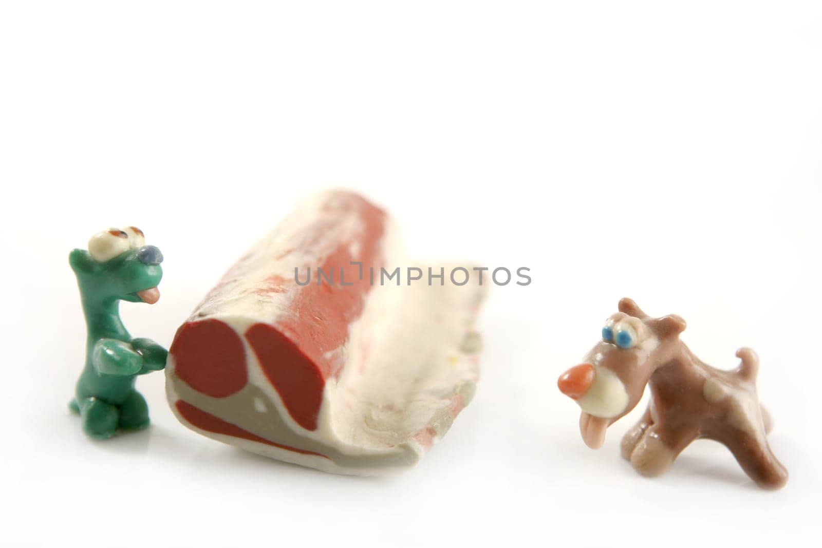 Handmade hungry plasticine dogs withy some meat to eat
