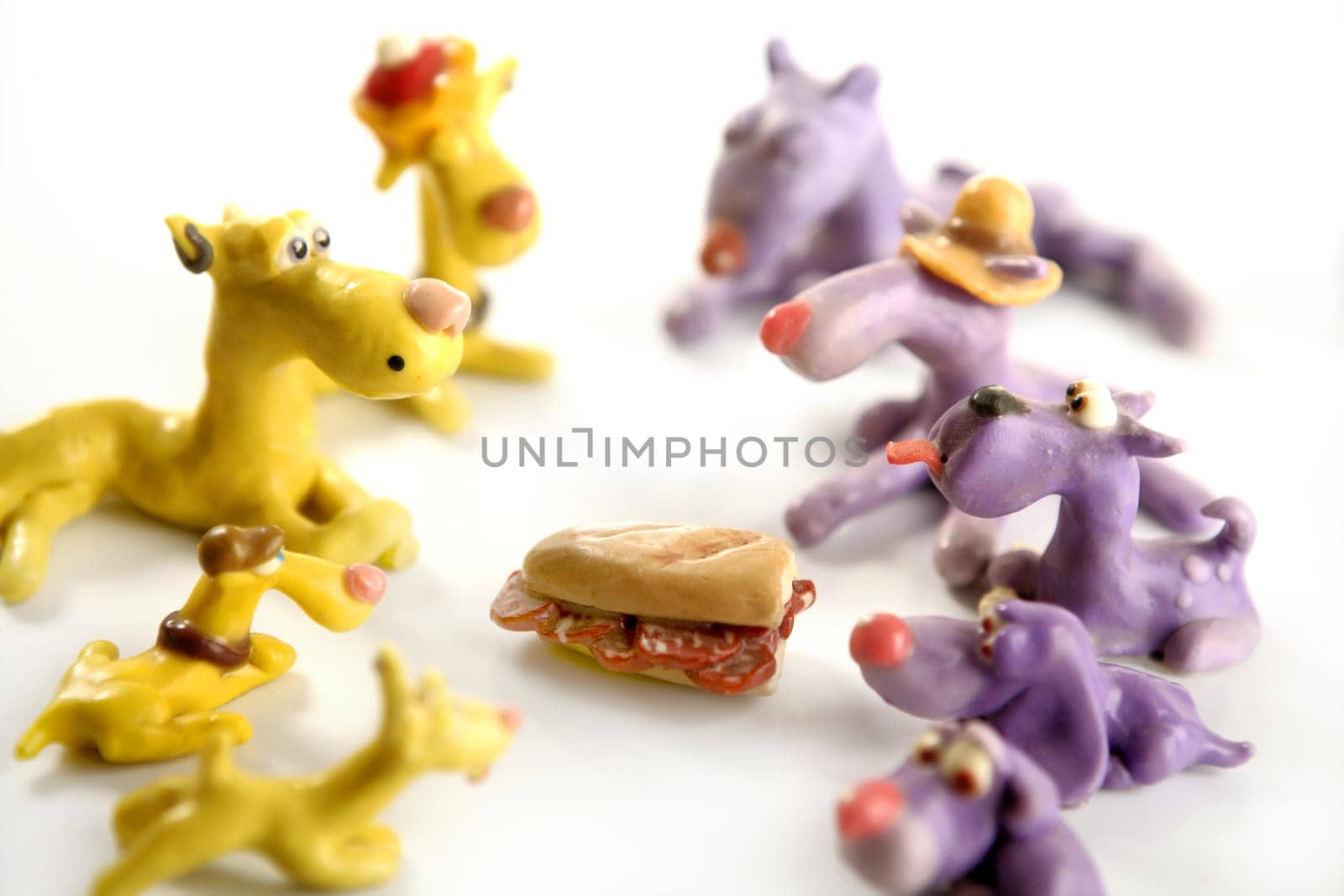 Handmade hungry plasticine dogs withy some meat to eat
