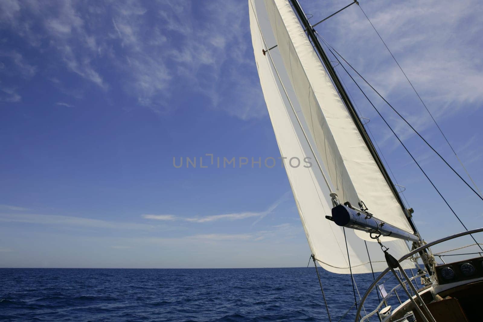 Sailboat sailing blue sea on sunny summer day in Mediterranean
