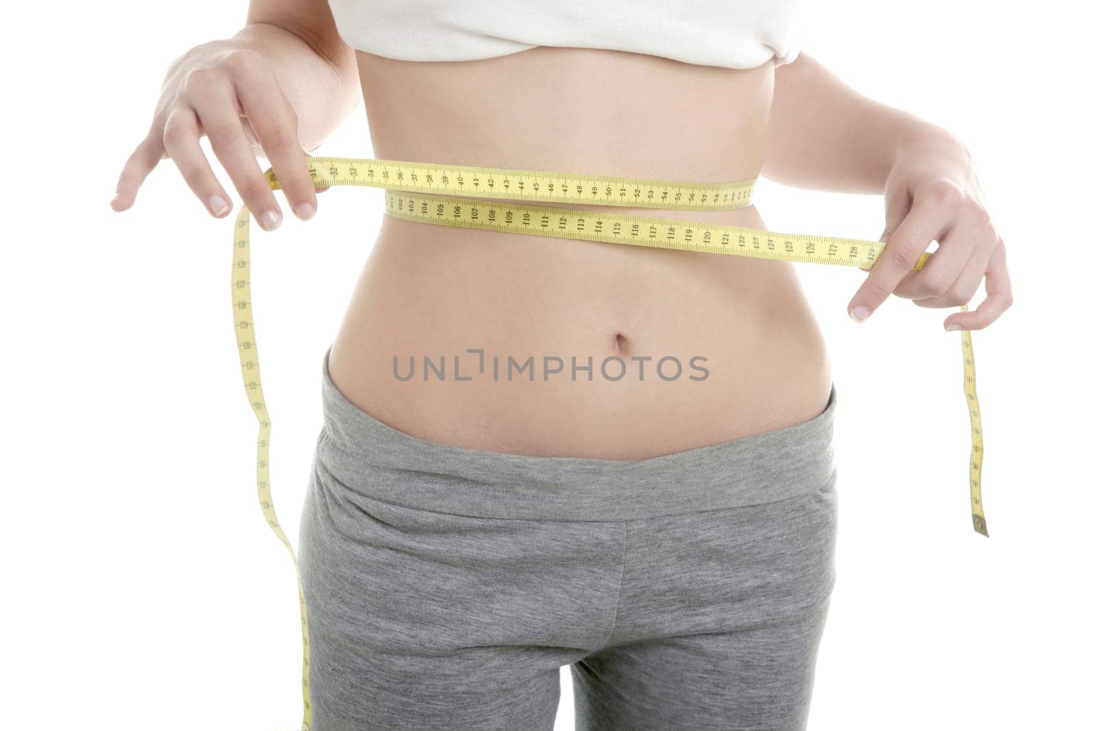 Beautiful in shape woman with yellow tape meter, white background