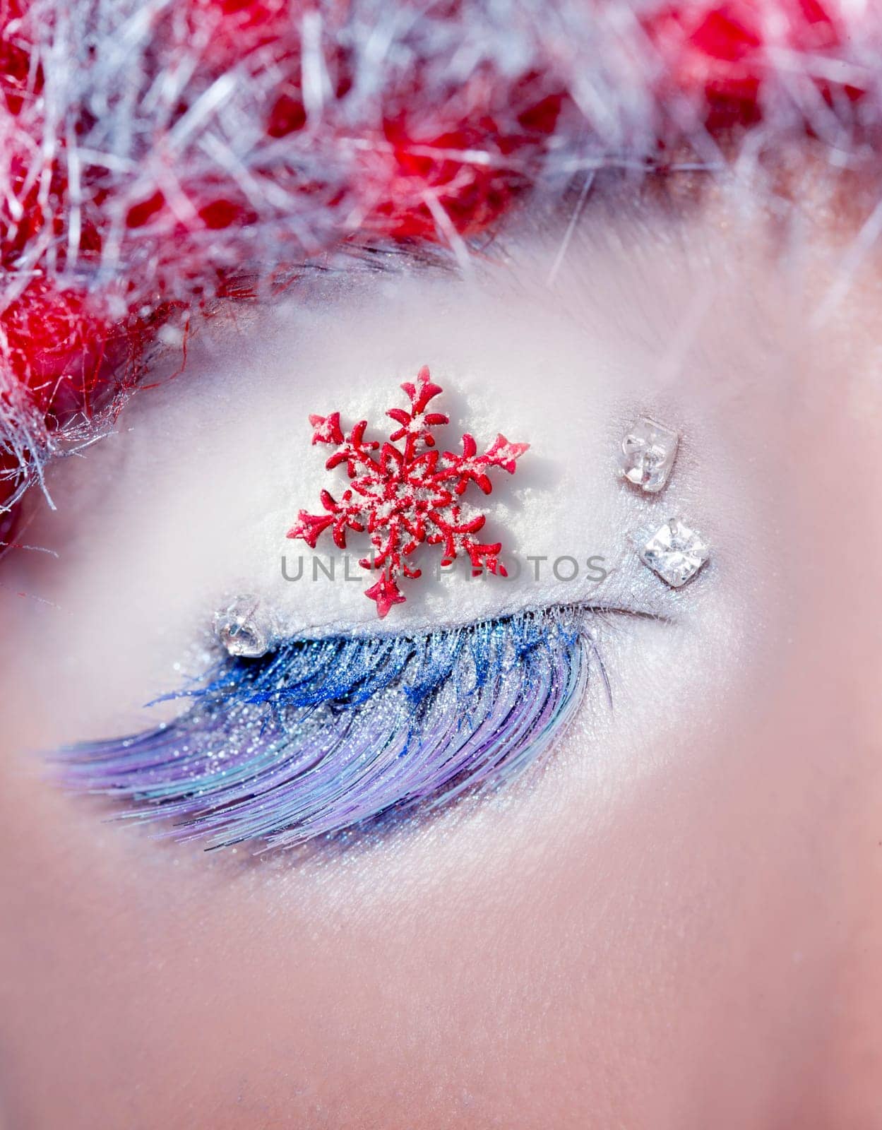 christmas star concept over a closed eye winter makeup and red hair