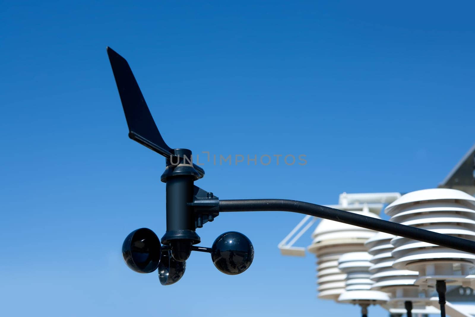 anemometer vane in weather station under blue sky