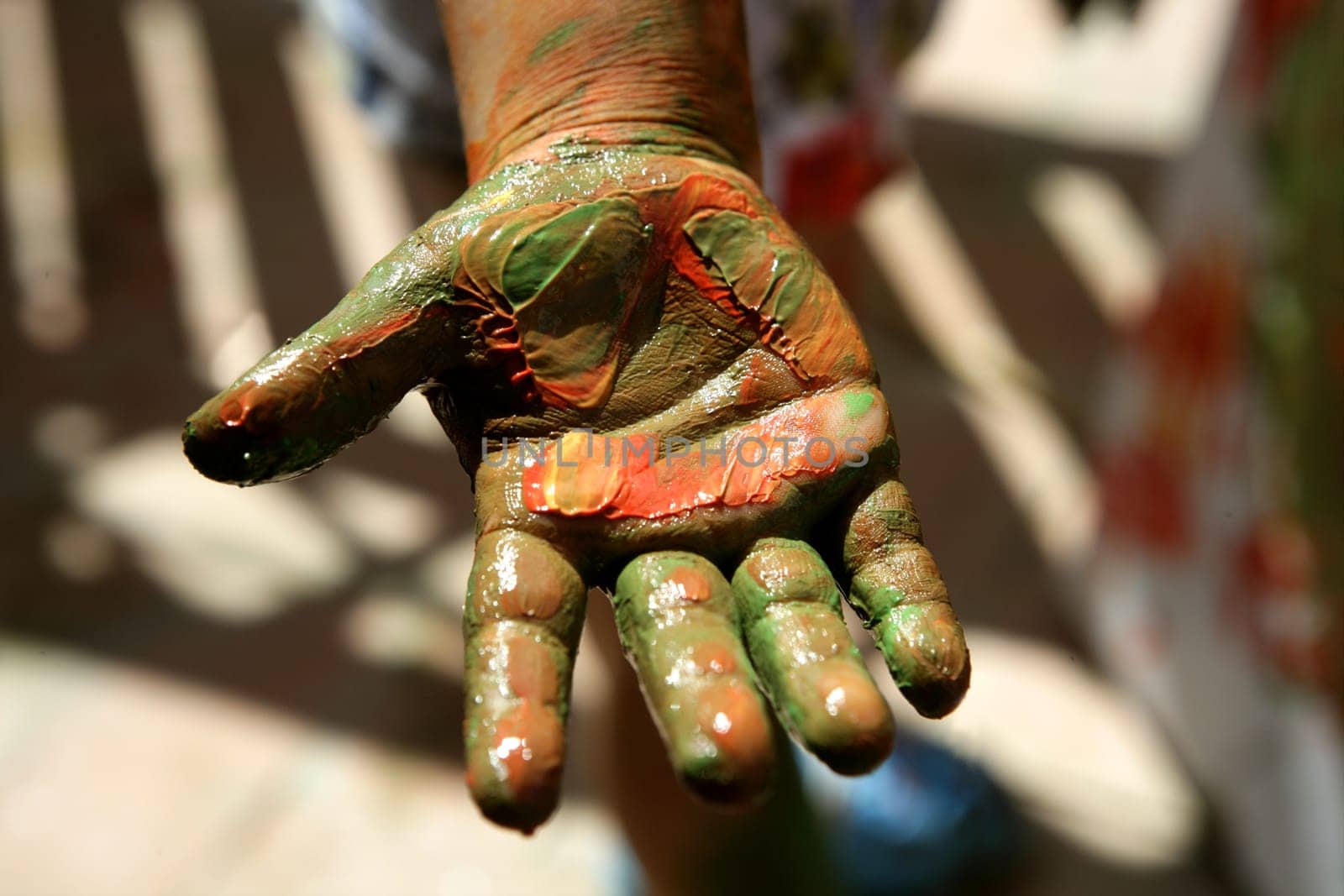 Children artist hands painting colorful with her fingers
