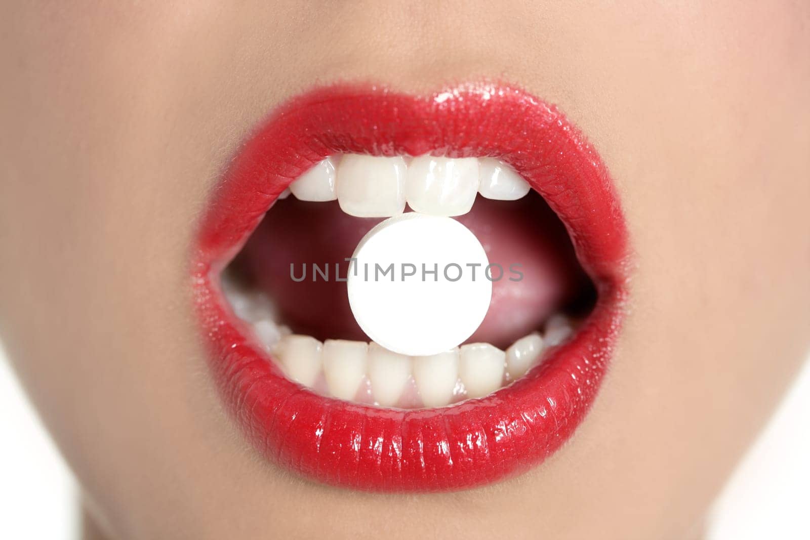 Beauty woman mouth with red lips and medicine pill