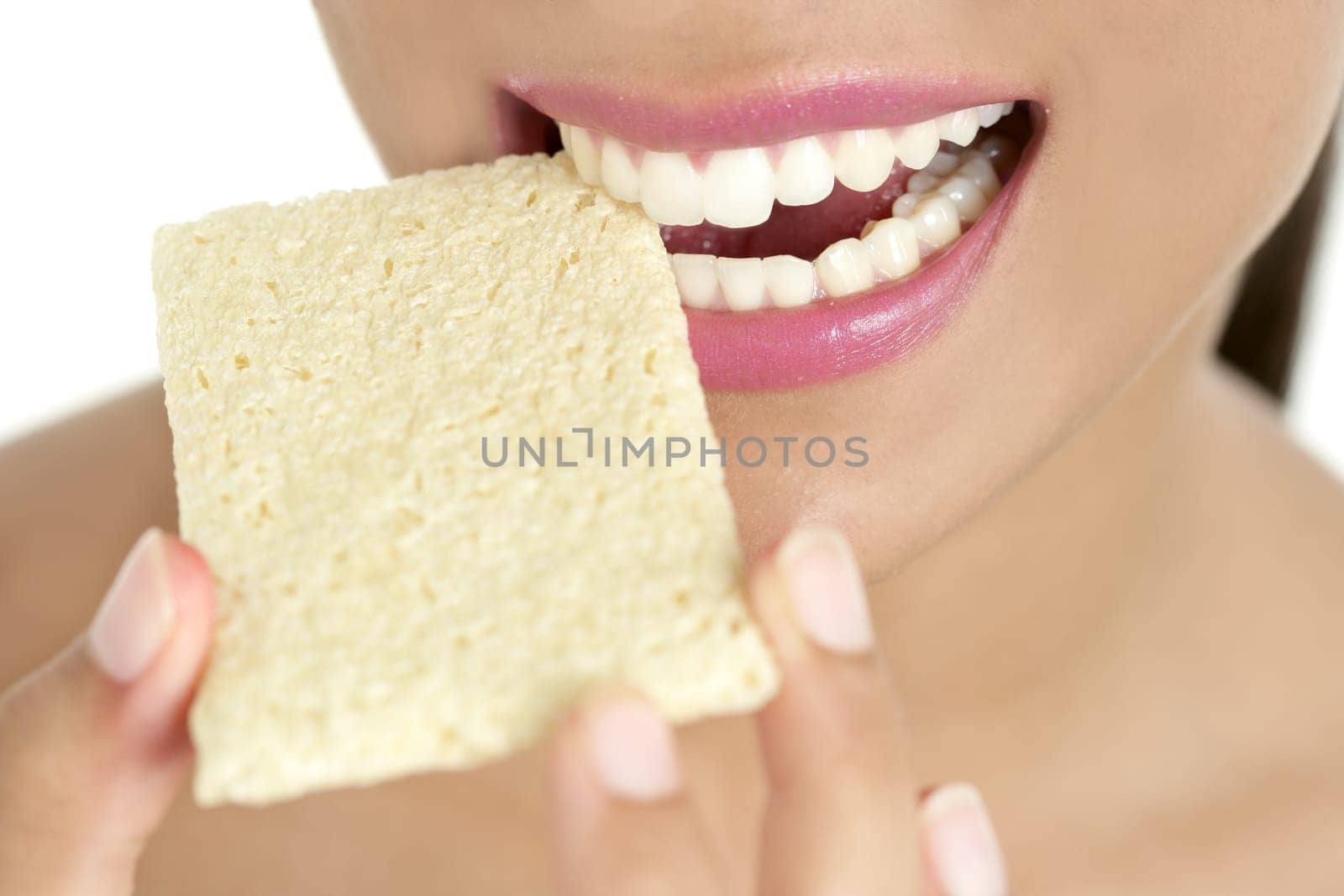 Biscuit in woman teeth and mouth having a healthy snack