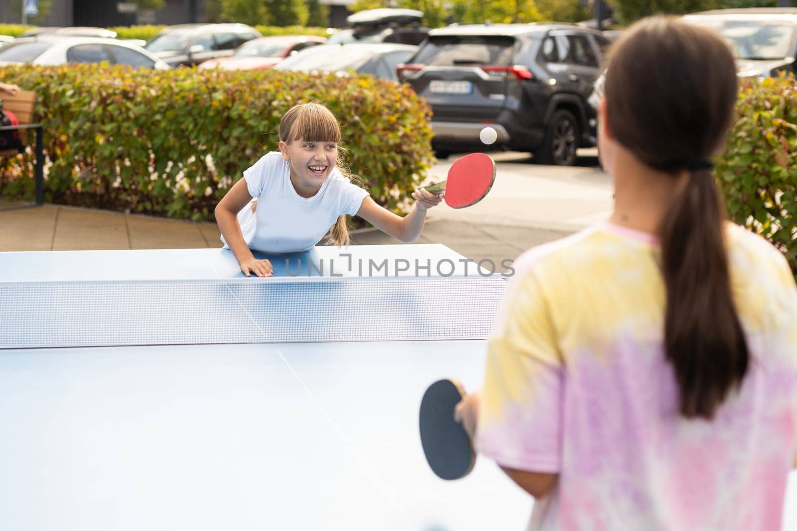 girl plays in table tennis outdoor by Andelov13