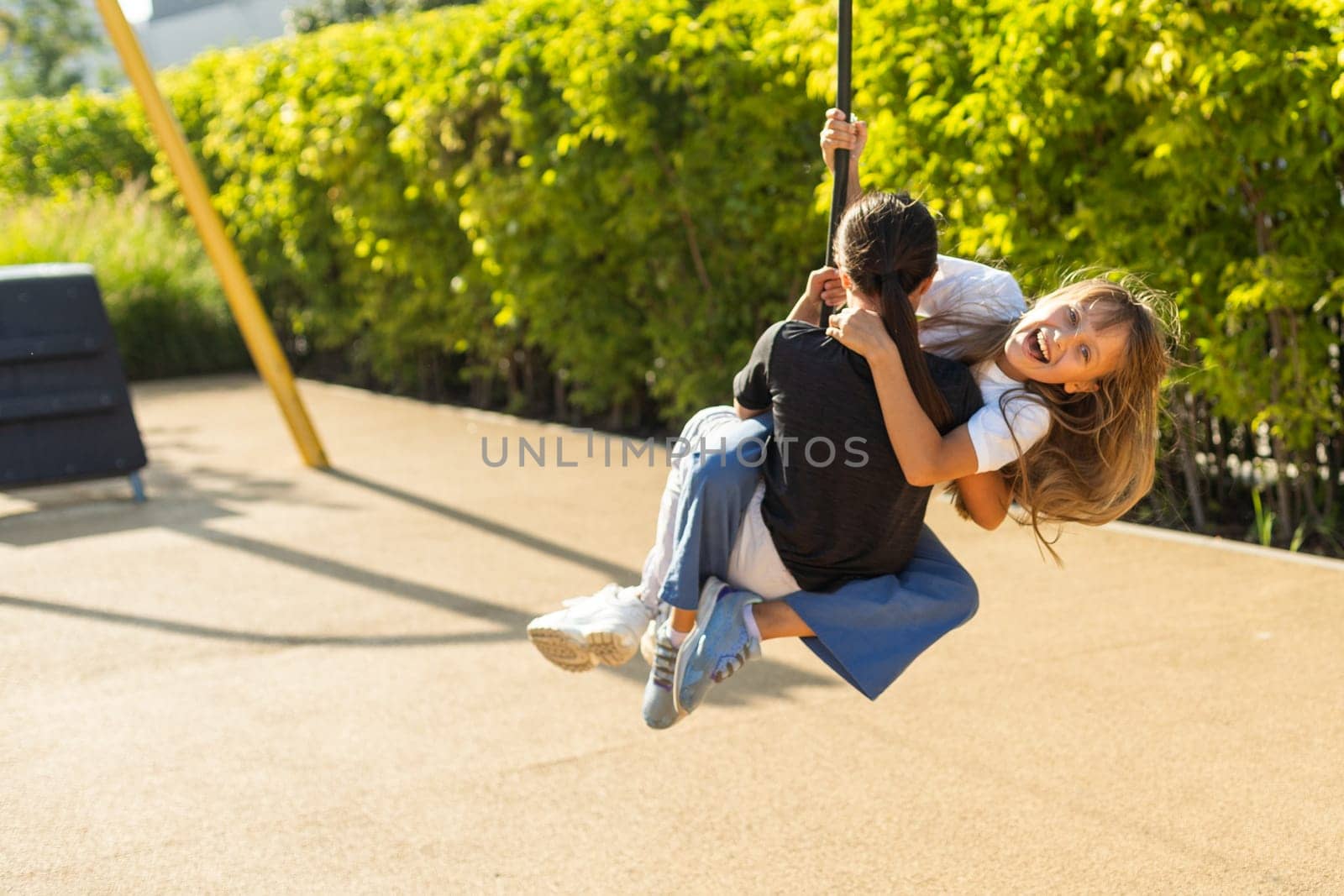 Caucasian little girls enjoying at outdoor children playground. Small girls playing at the park. High quality photo
