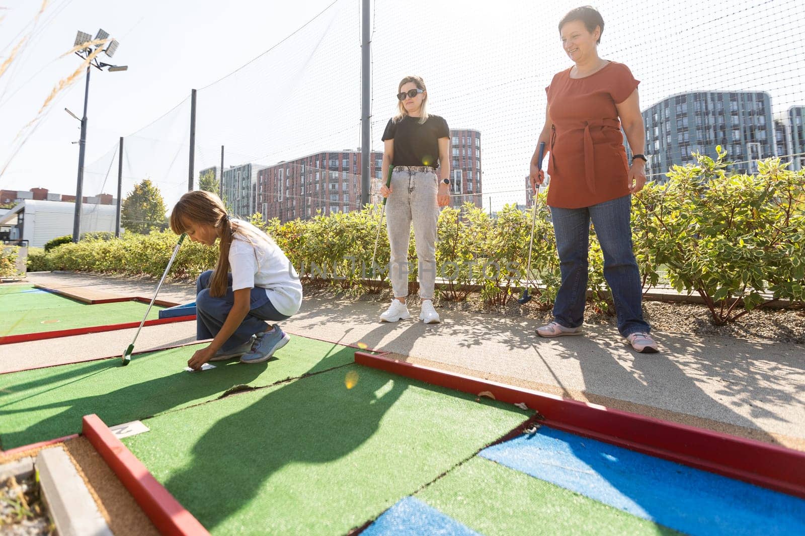 family playing mini golf on a cruise liner. Child having fun with active leisure on vacations. High quality photo