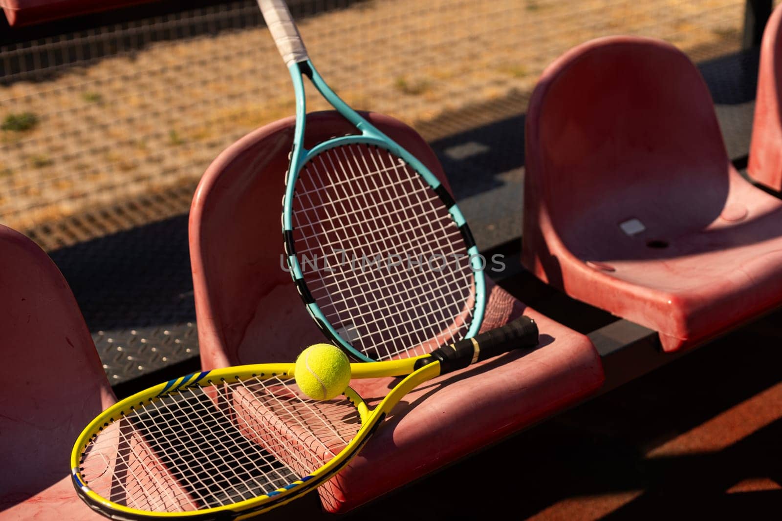 Close up view of tennis racket and balls on the clay tennis court by Andelov13