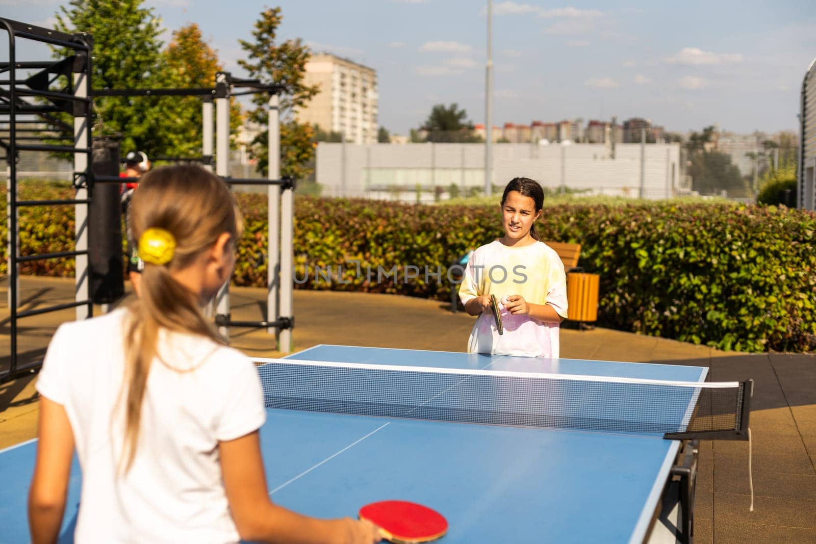 girl plays in table tennis outdoor. High quality photo