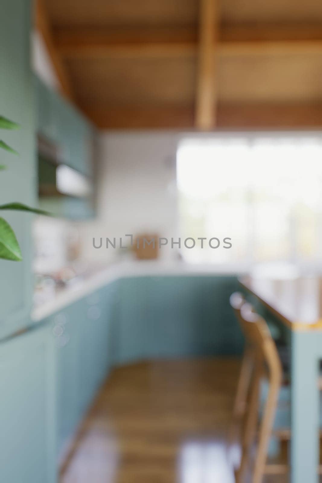 The large green kitchen is out of focus. Green kitchen interior in bokeh. 3D rendering