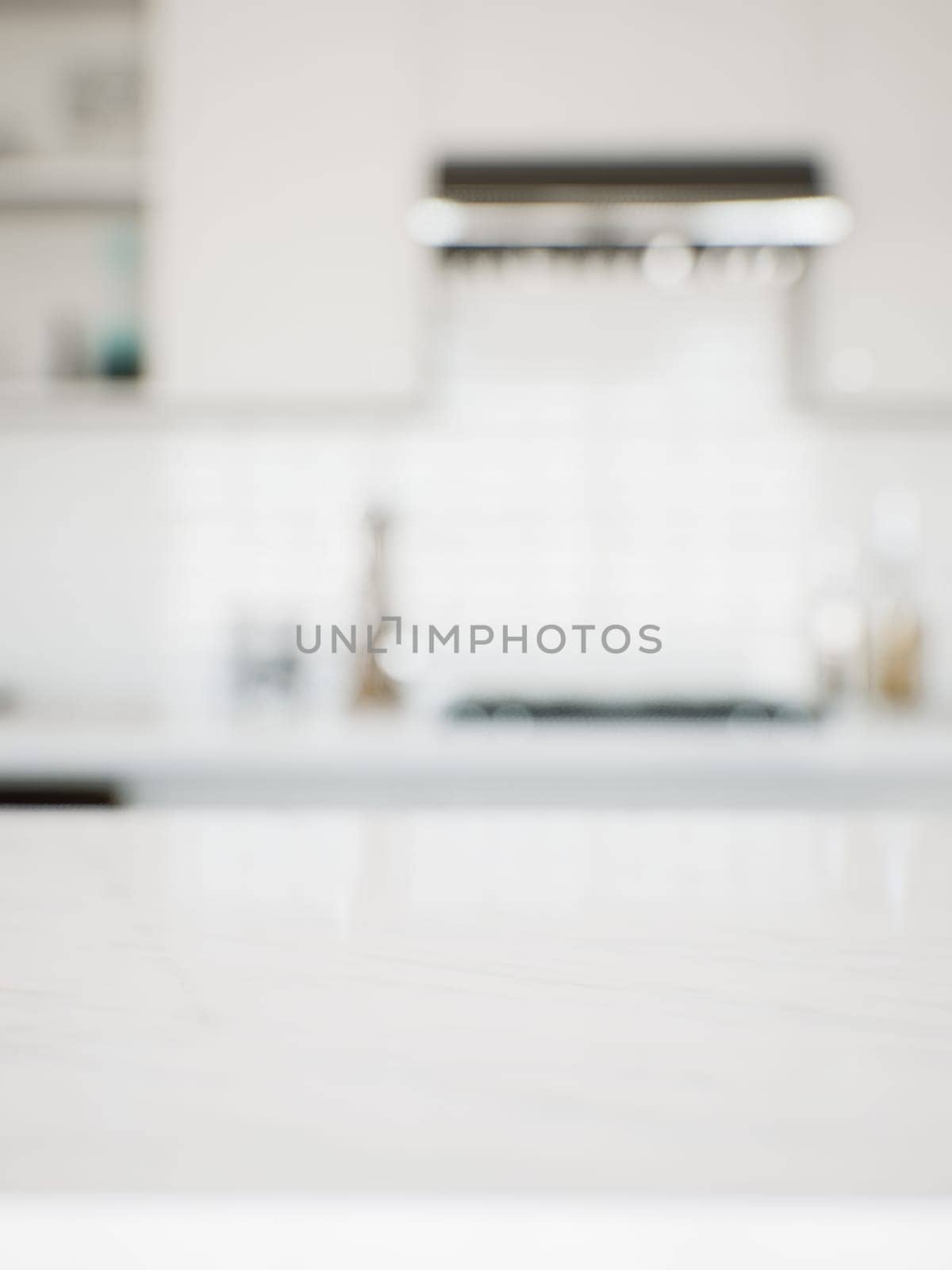 Focus on the marble countertop against the backdrop of kitchen appliances and utensils. by N_Design