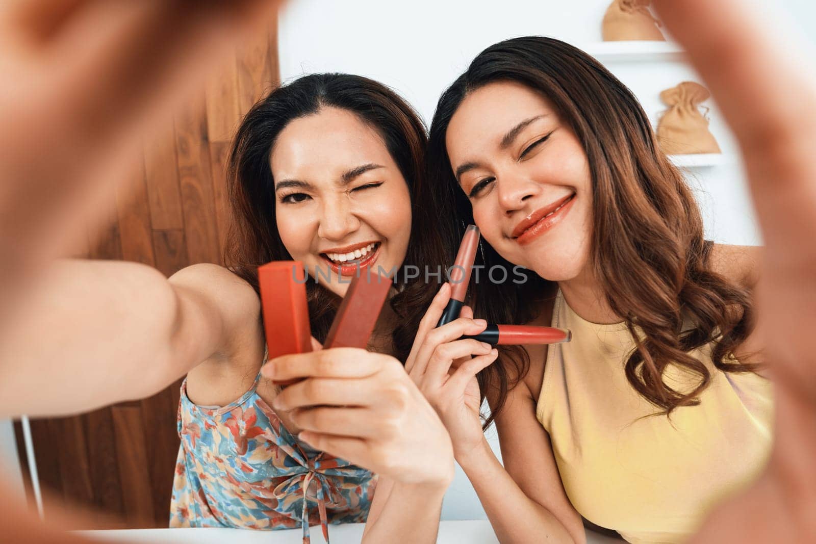 Woman influencer shoot live streaming vlog video review makeup uttermost social media or blog. Happy young girl with cosmetics studio lighting for marketing recording session broadcasting online.