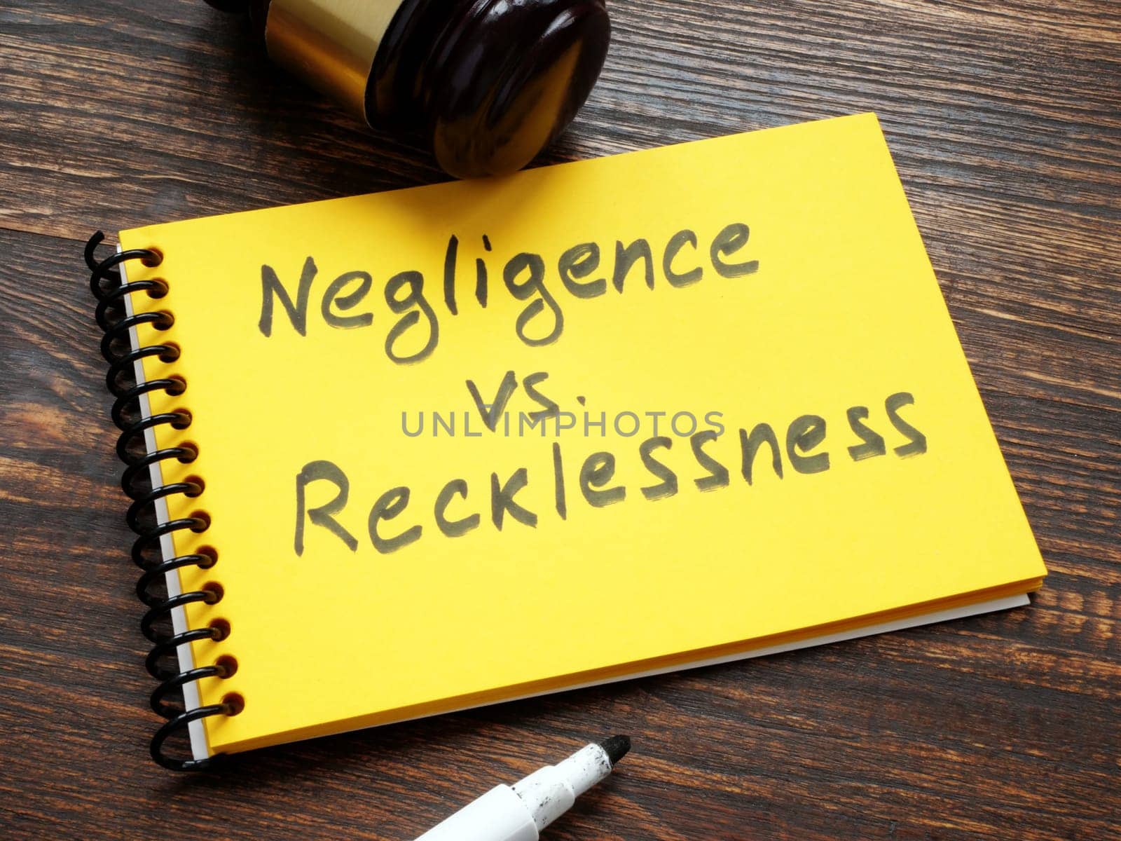 Negligence vs recklessness inscription and a gavel. by designer491