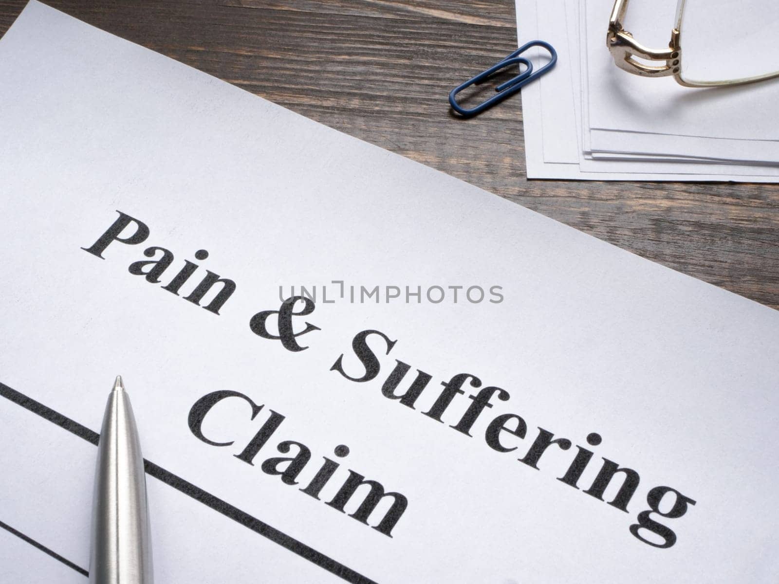 Pain and suffering claim with a pen for signing. by designer491