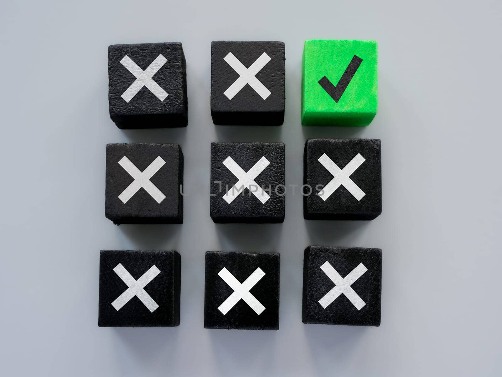 Black cubes and one green as concept for errors and correct answer or solution. by designer491