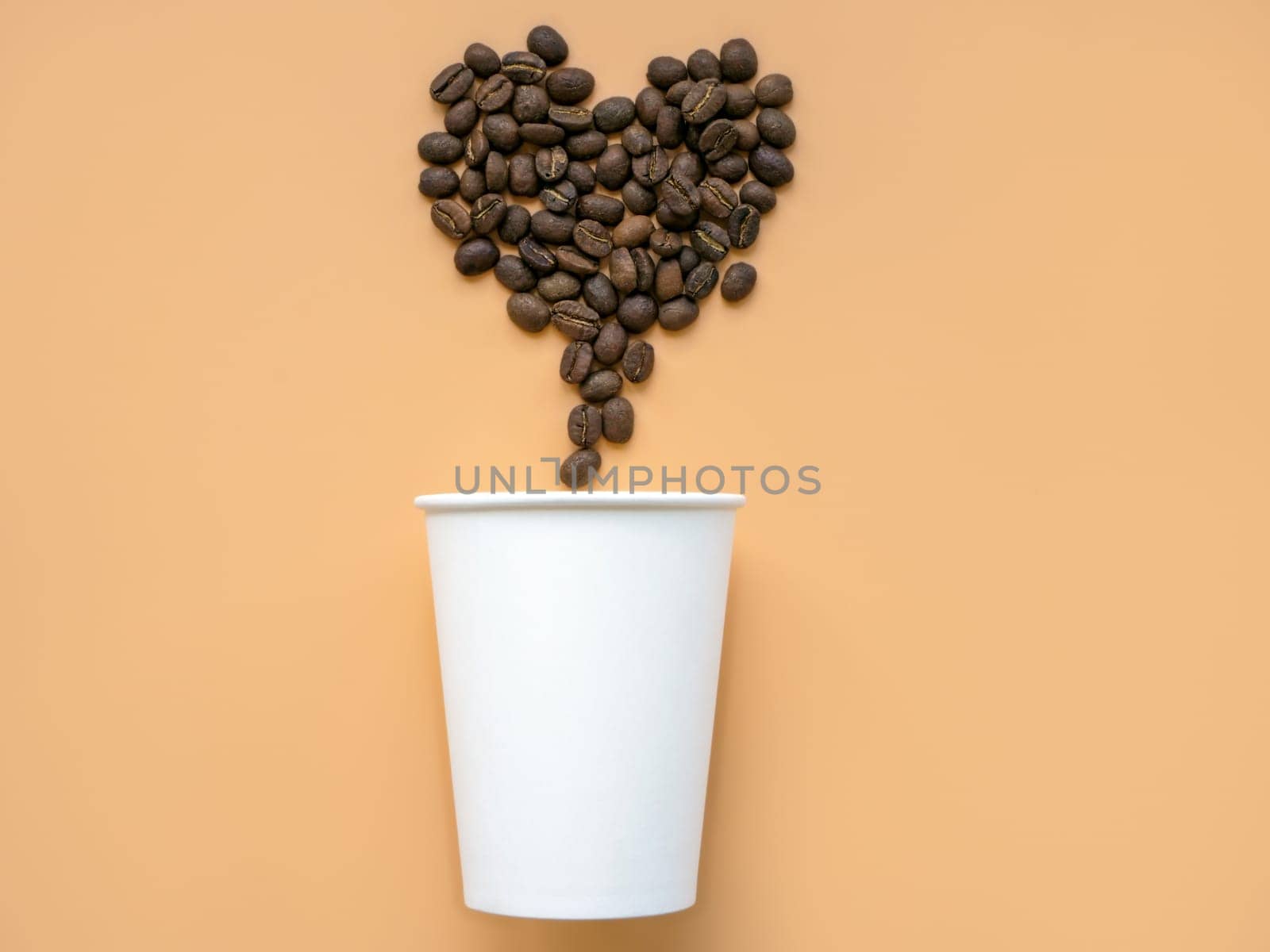 Paper cup and coffee beans in the shape of a heart. Minimal modern trendy art.