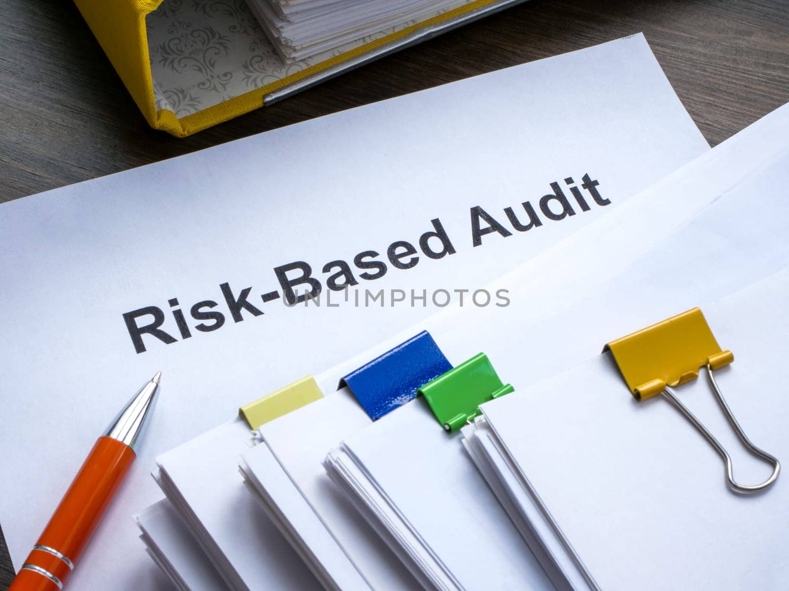 Risk based audit report and a pen. by designer491