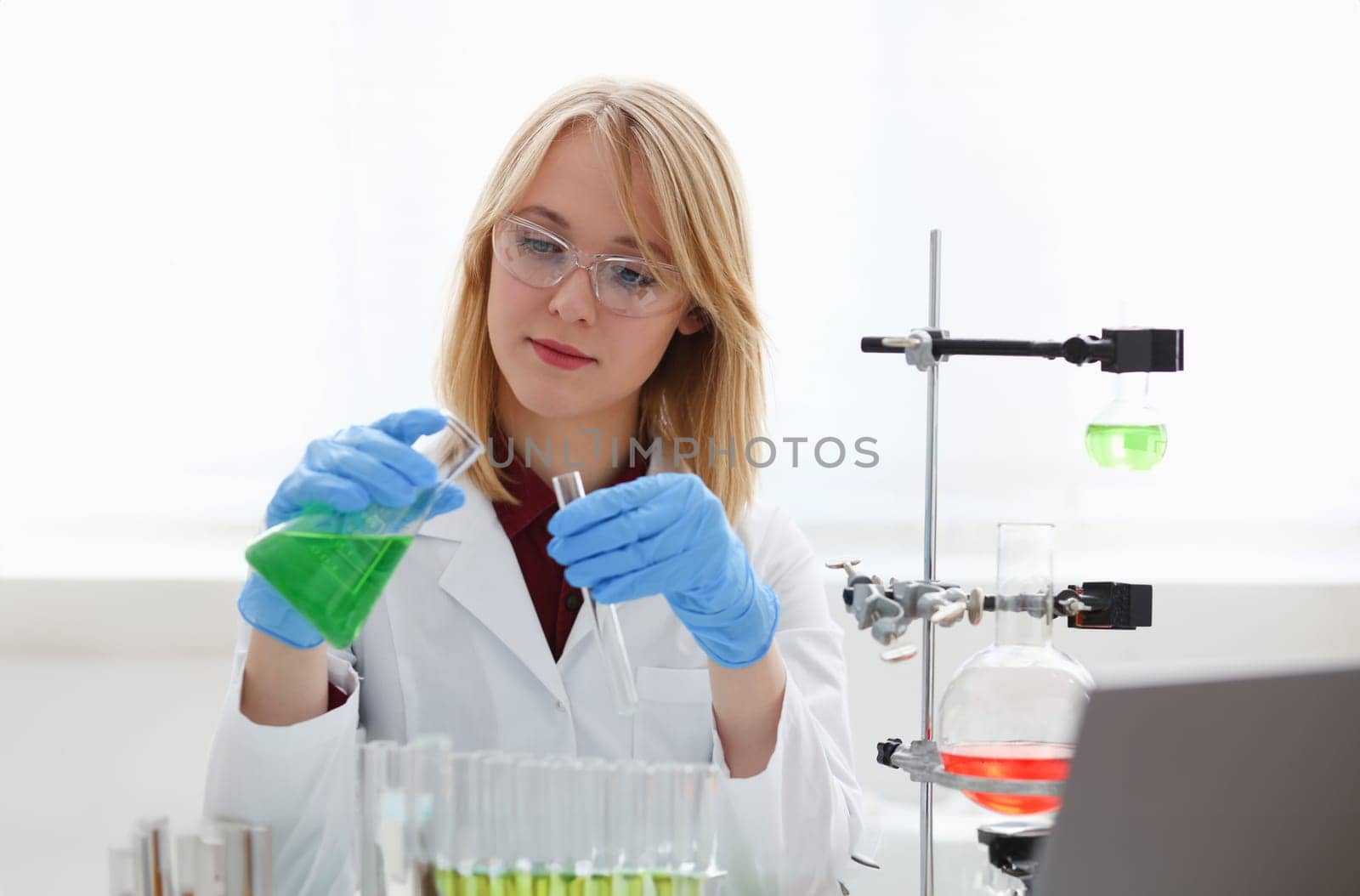 Technician hold in arms in protective gloves sample bottle with poison fluid portrait. Medical worker in uniform use reagent tube for virus infection exam or biological toxic reaction drug creation