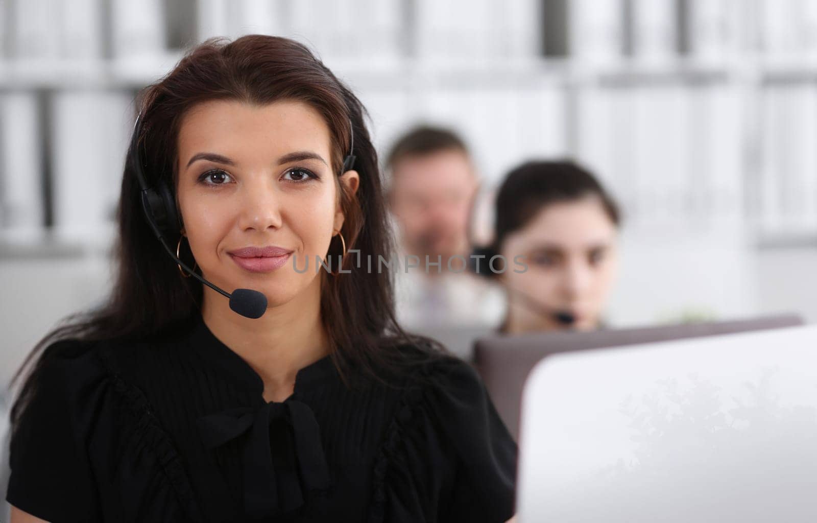Three call centre service operators at work by kuprevich
