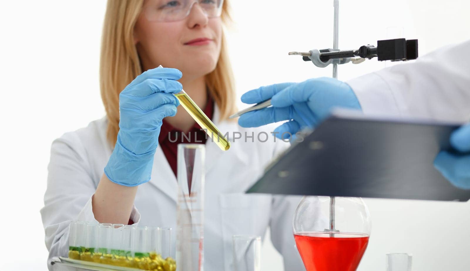 Technician hold in arms in protective gloves sample bottle with poison fluid portrait. Medical worker in uniform use reagent tube for virus infection exam or biological toxic reaction drug creation