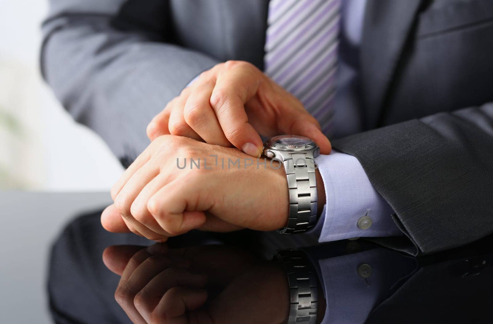Man in suit and tie check out time at silver wristwatch closeup. Waste minute modern punctual life style start hurry job idea last second clockwork precision concept
