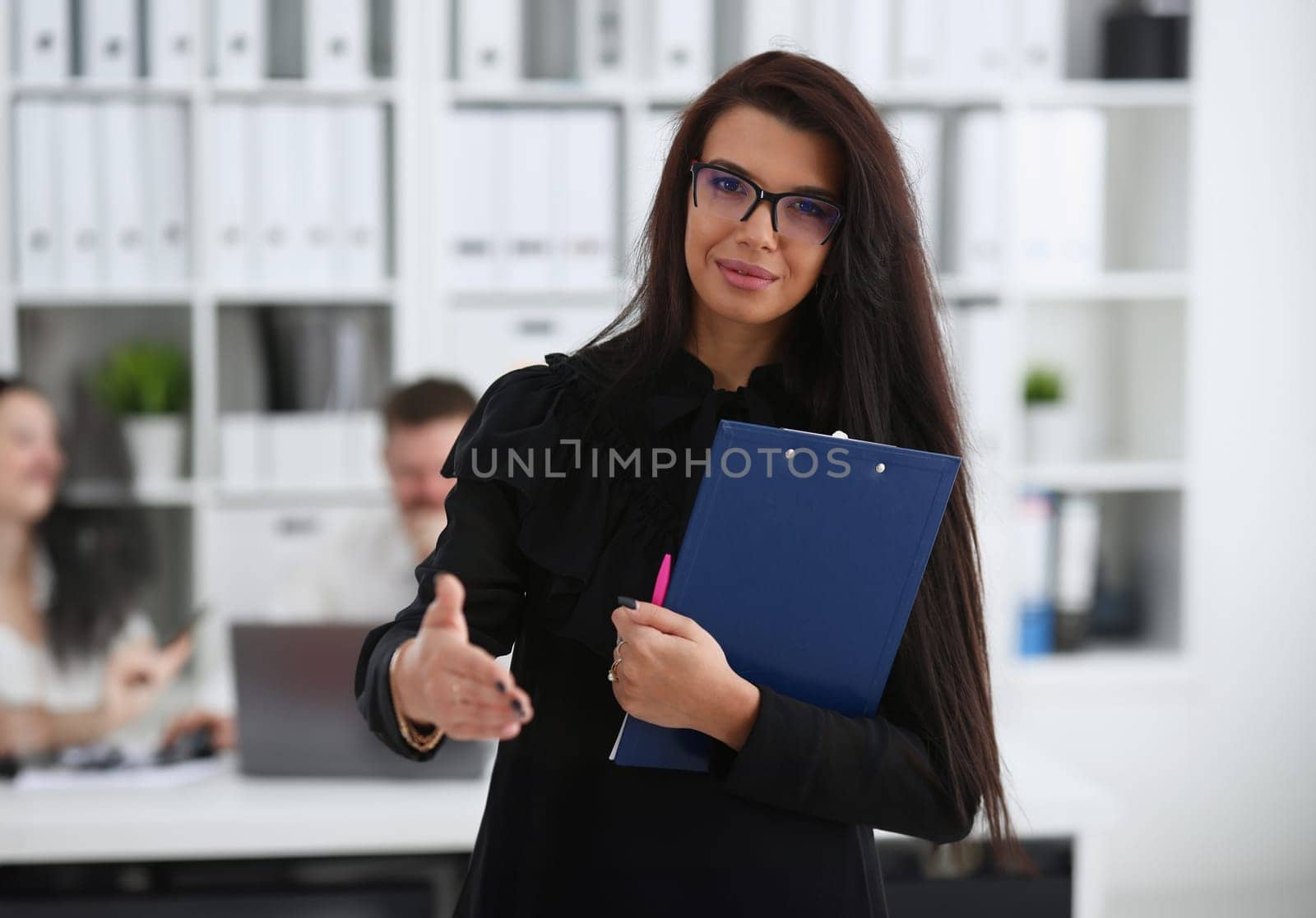 Woman hold document pad give arm as hello in office portrait. Friend welcome mediation offer positive introduction thanks gesture summit participate approval motivation male arm strike bargain