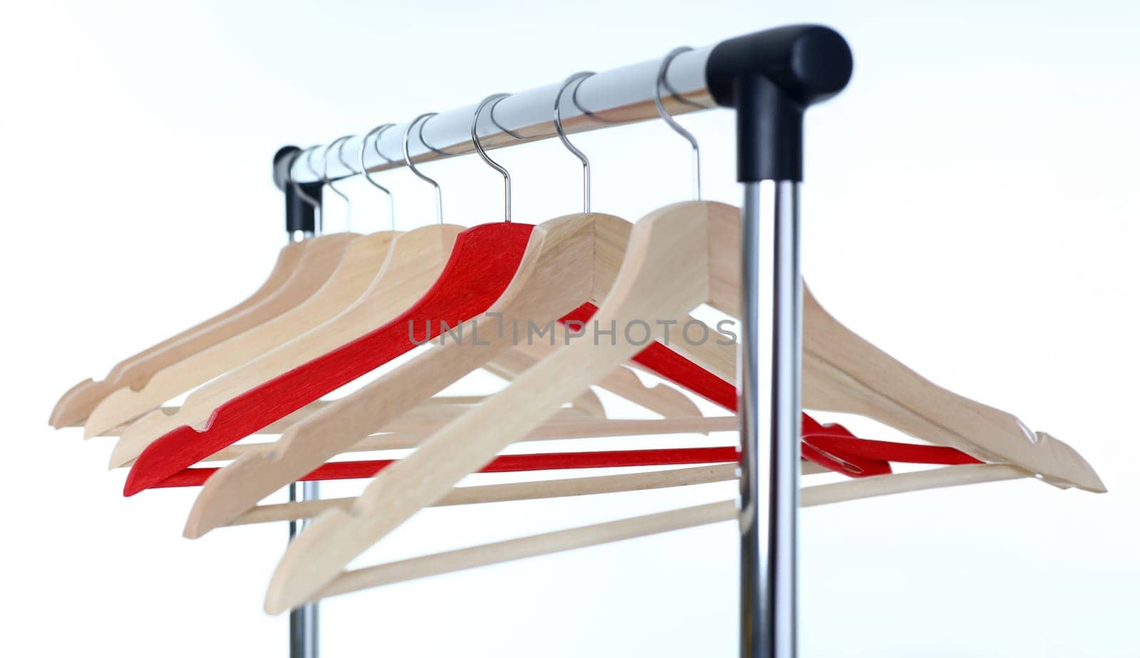Red and wooden hanger hanging on metal pipe business leader selling clothes and style