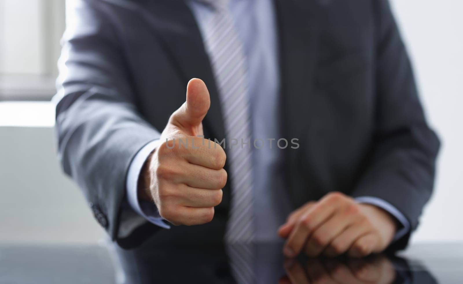 Male hand showing ok or confirm sign with thumb up during conference closeup. High level and quality product serious offer mediation solution happy client creative adviser participation concept