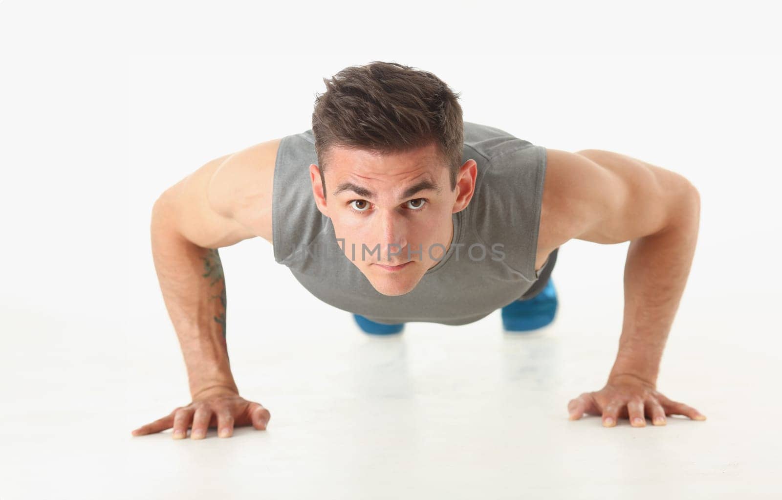 Fitness man wringing from the floor demonstrates good physical exercises isolated on white background. Healthy lifestyle for many people exercising their own weight for losing for every day push up.