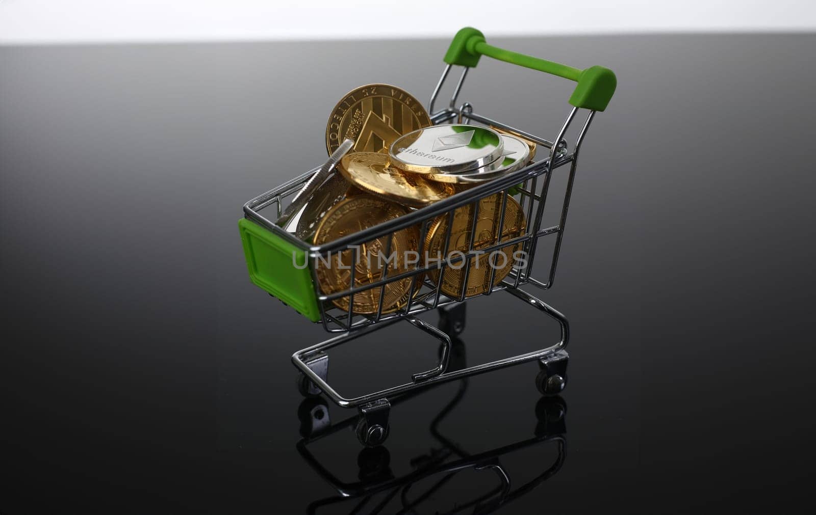 Basket from supermarket with coins crypto currency e bitcoin ethereum litetcoin on a black gray background with reflection exchange purchase sale exchanger closeup.