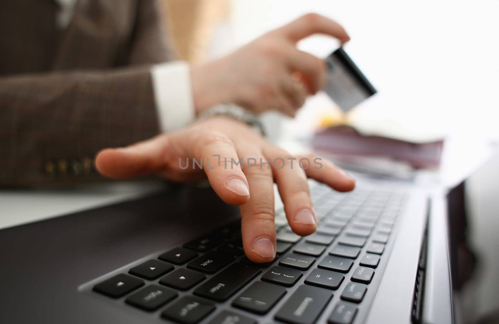Male arms hold credit card press buttons making transfer closeup. Anti-fraud financial security when entering client discount program number or filling personal credential password login to account