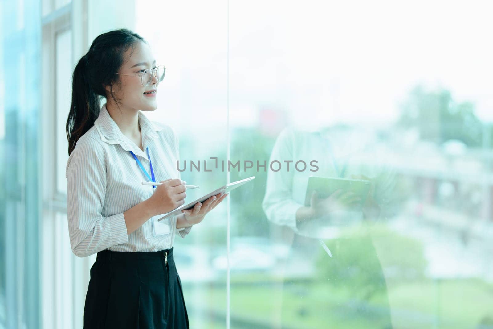 Portrait of a woman business owner showing a happy smiling face as he has successfully invested her business using financial budget documents at work.