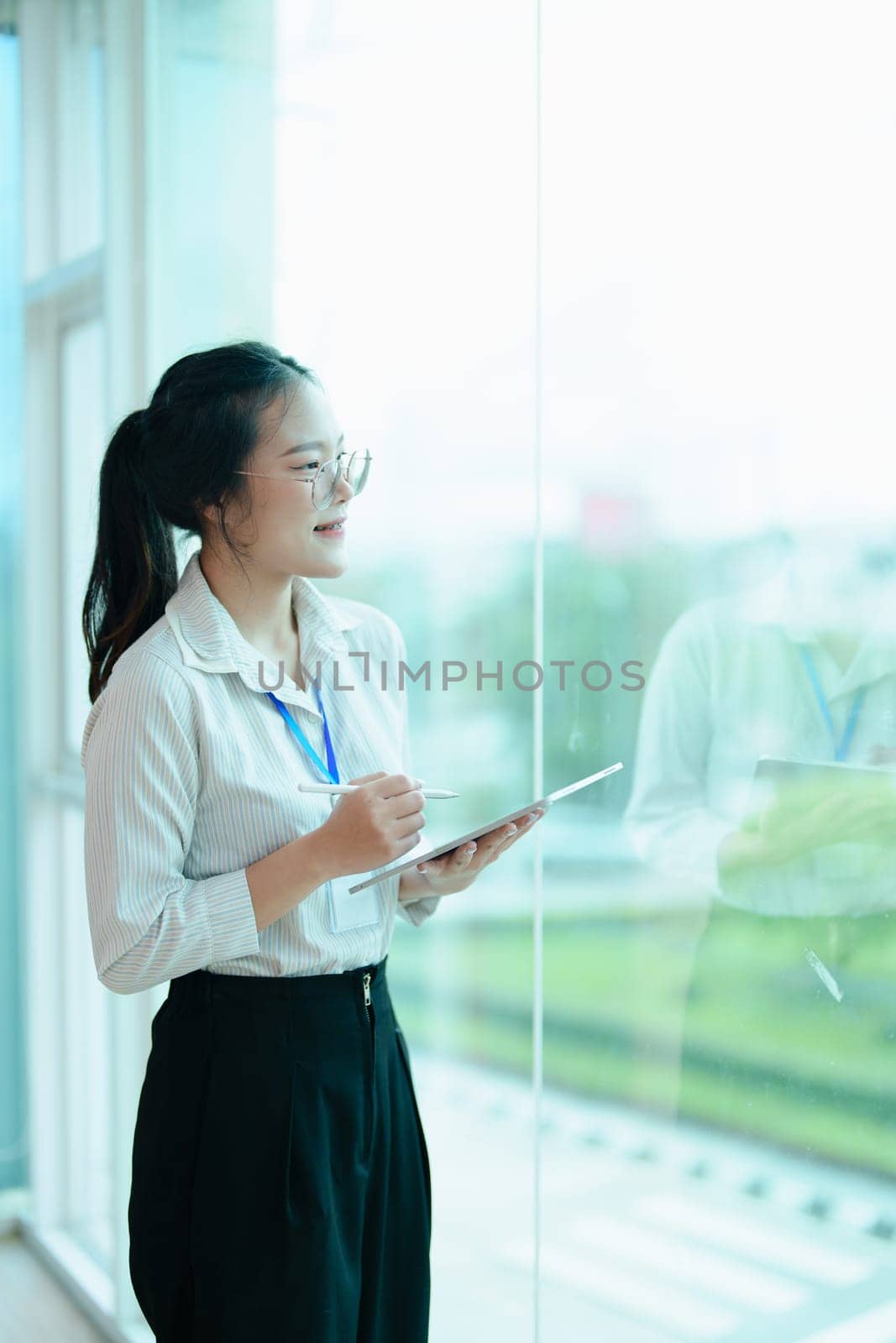 Portrait of a woman business owner showing a happy smiling face as he has successfully invested her business using financial budget documents at work.