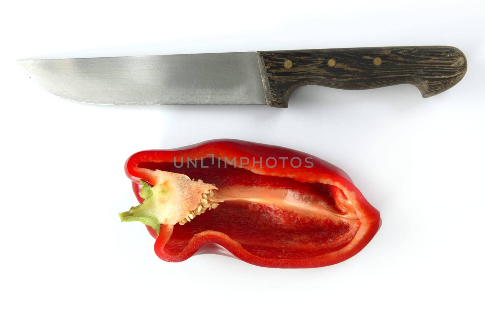 Red pepper and kitchen knife over white background