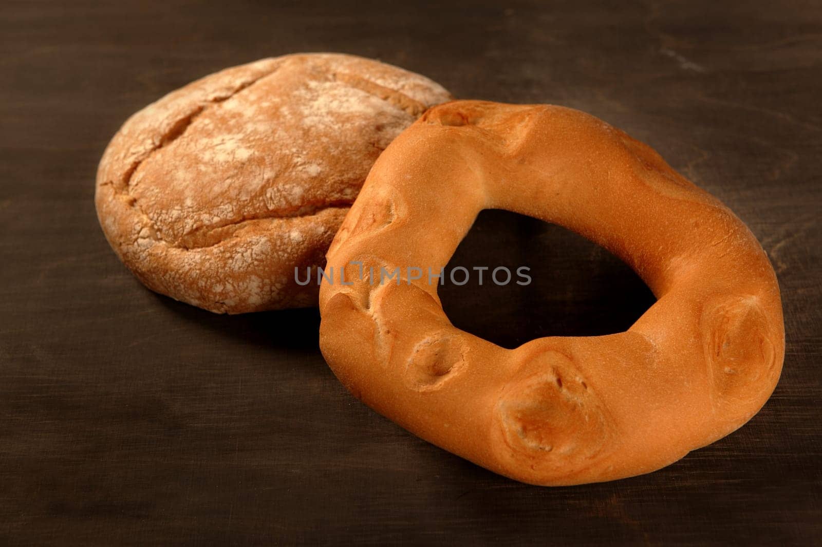Bread with round shape over dark wood background