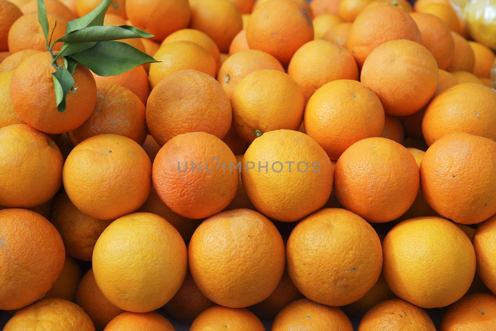 Valencia oranges stacked on market in mediterranean spain