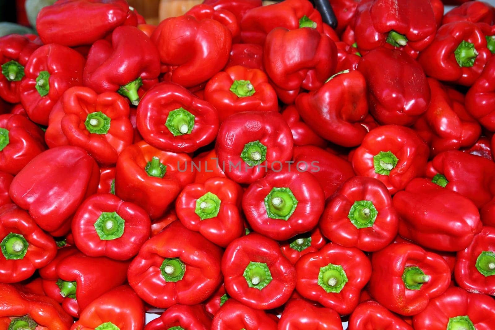 Red pepper stacked in market as pattern background vegetables