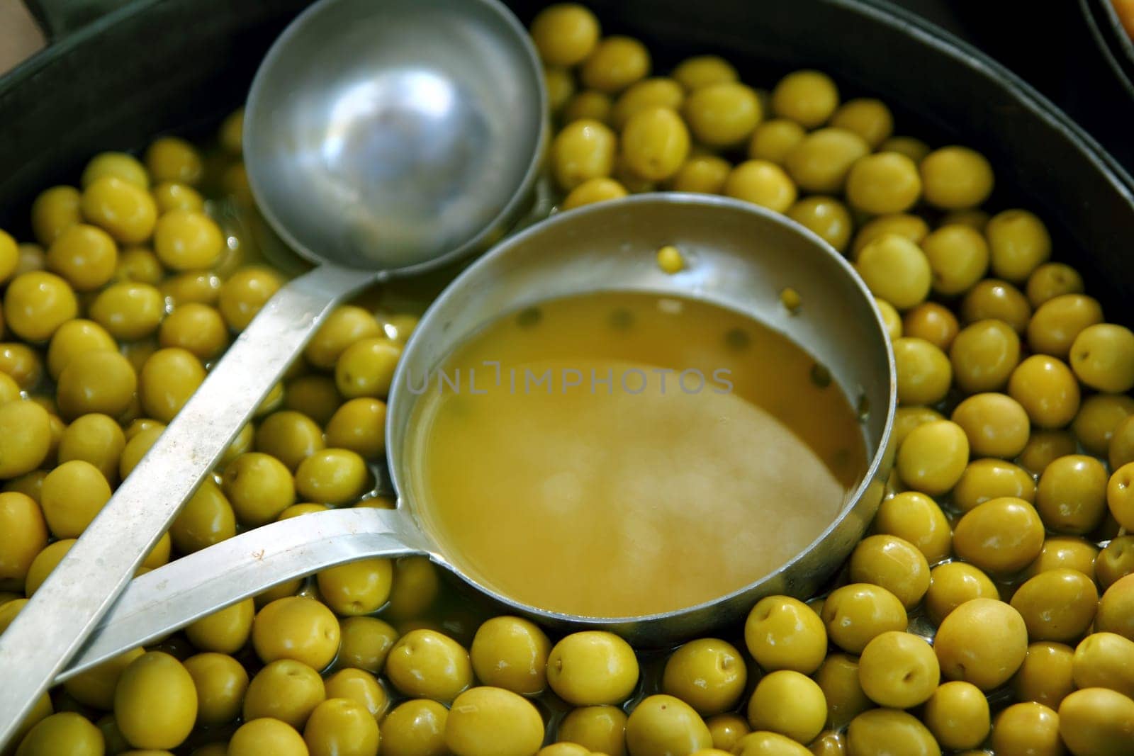 olives in pickling brine pattern background texture in market