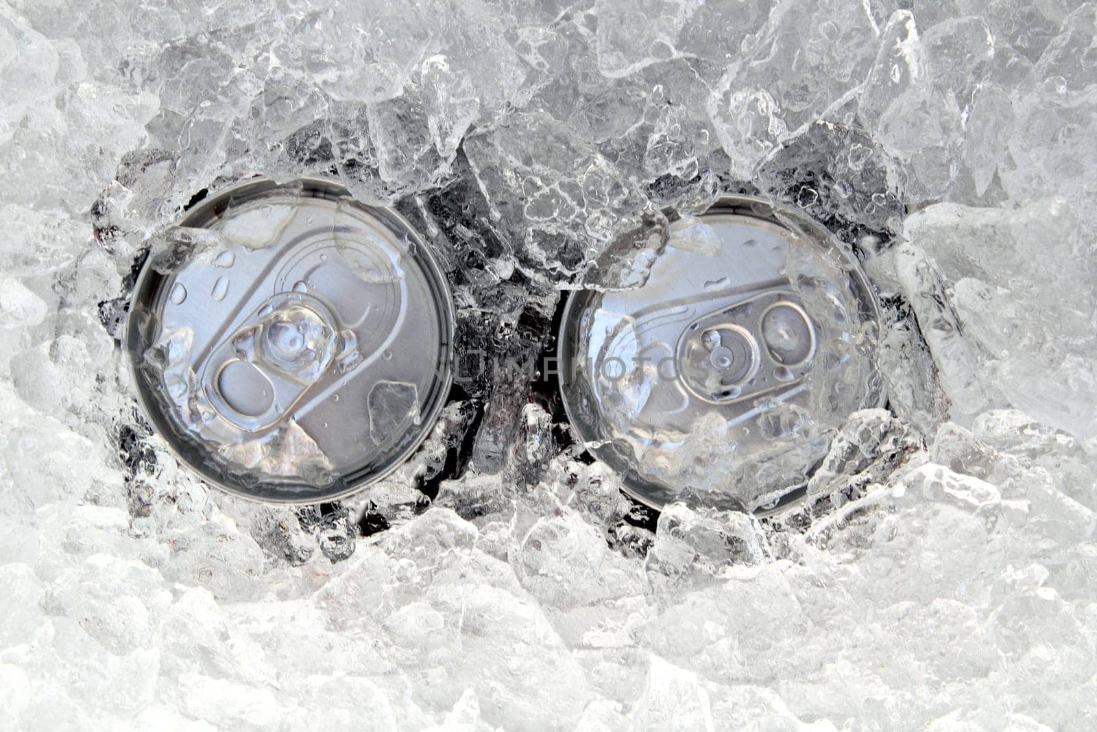 two drink can iced submerged in frost ice closeup