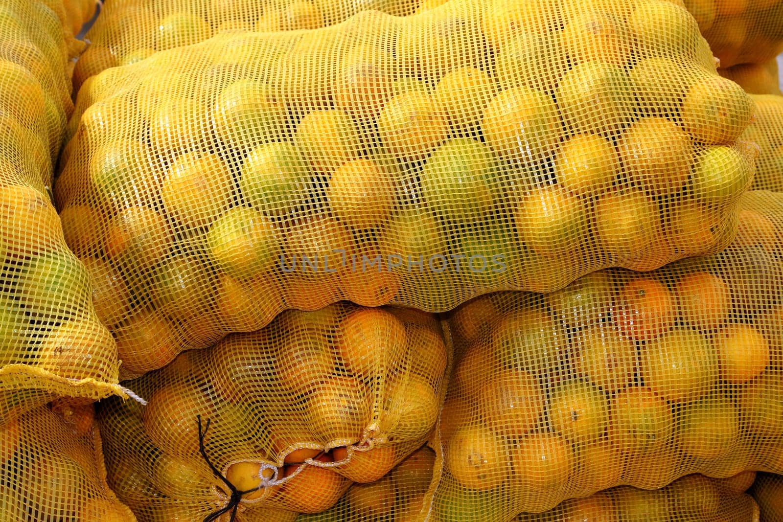 many orange sack citrus stacked fruits