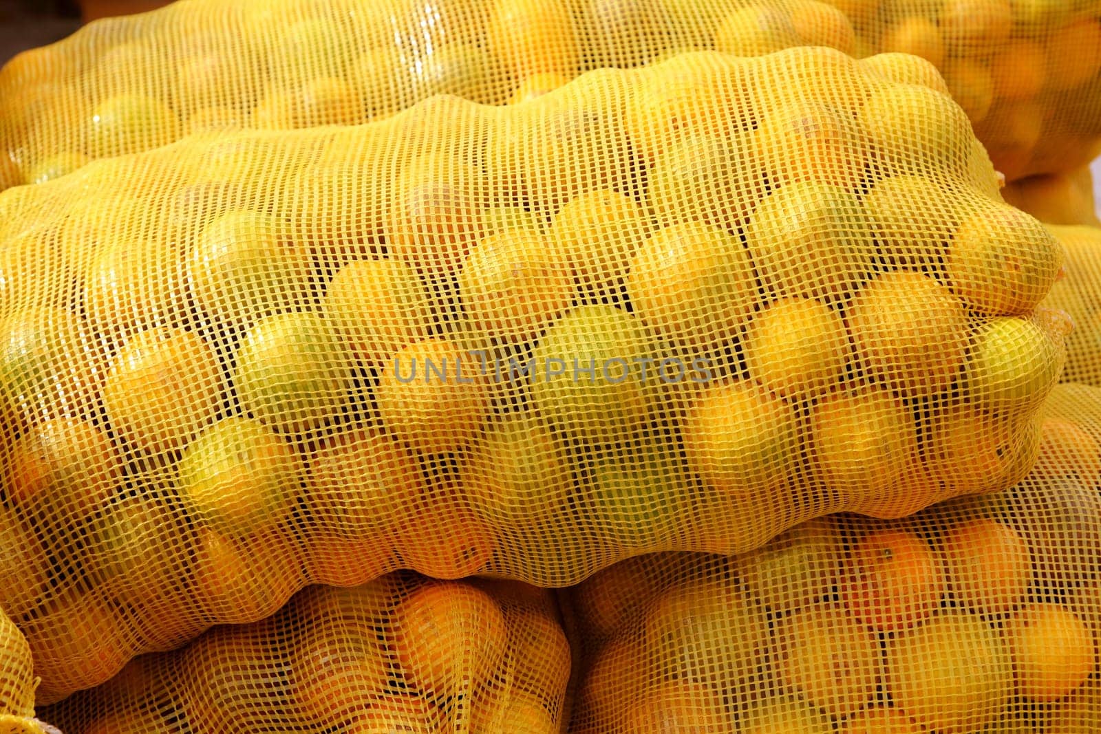 many orange sack citrus stacked fruits