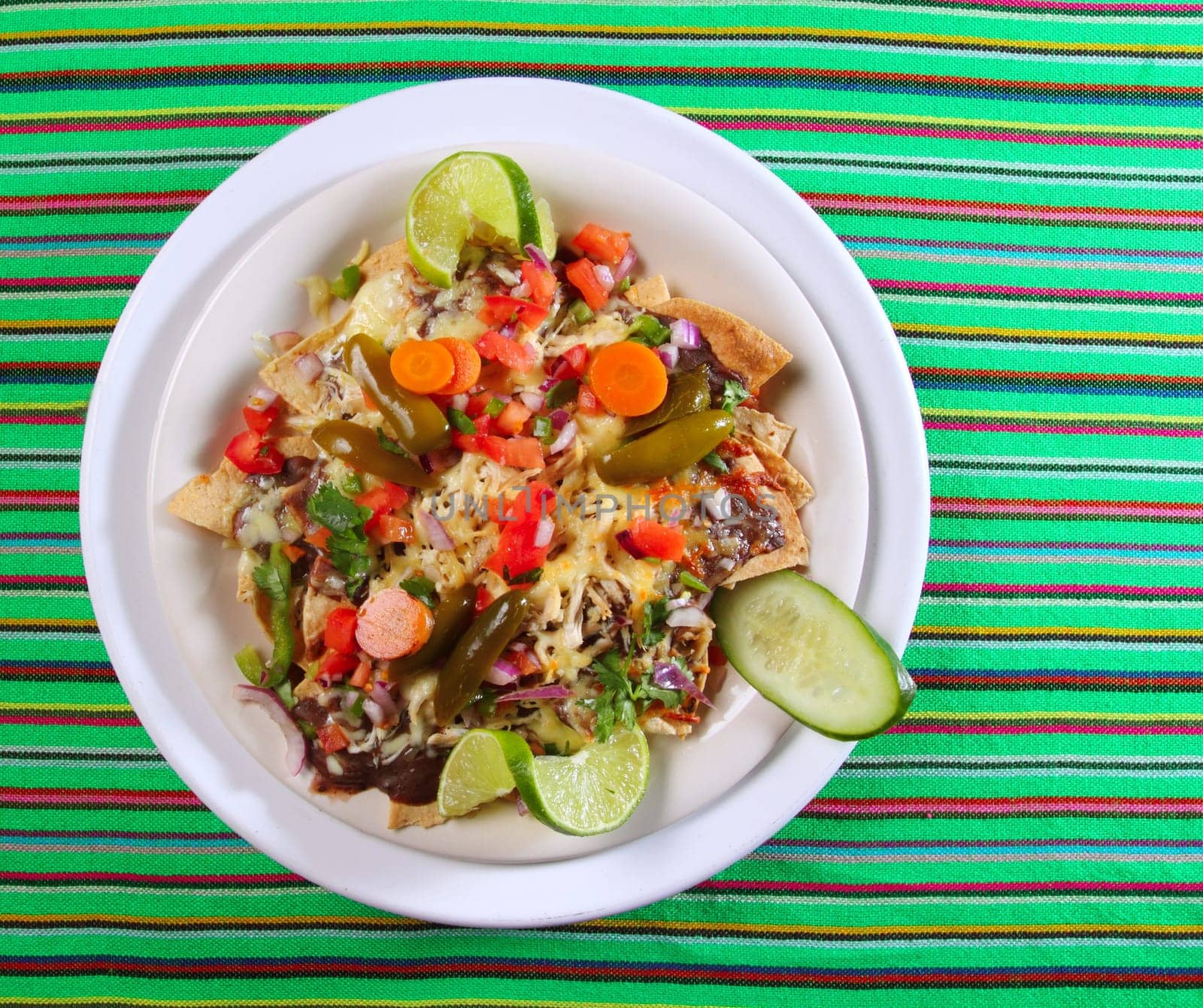 Nachos totopos prepared with cheese vegetables chili Mexican food style
