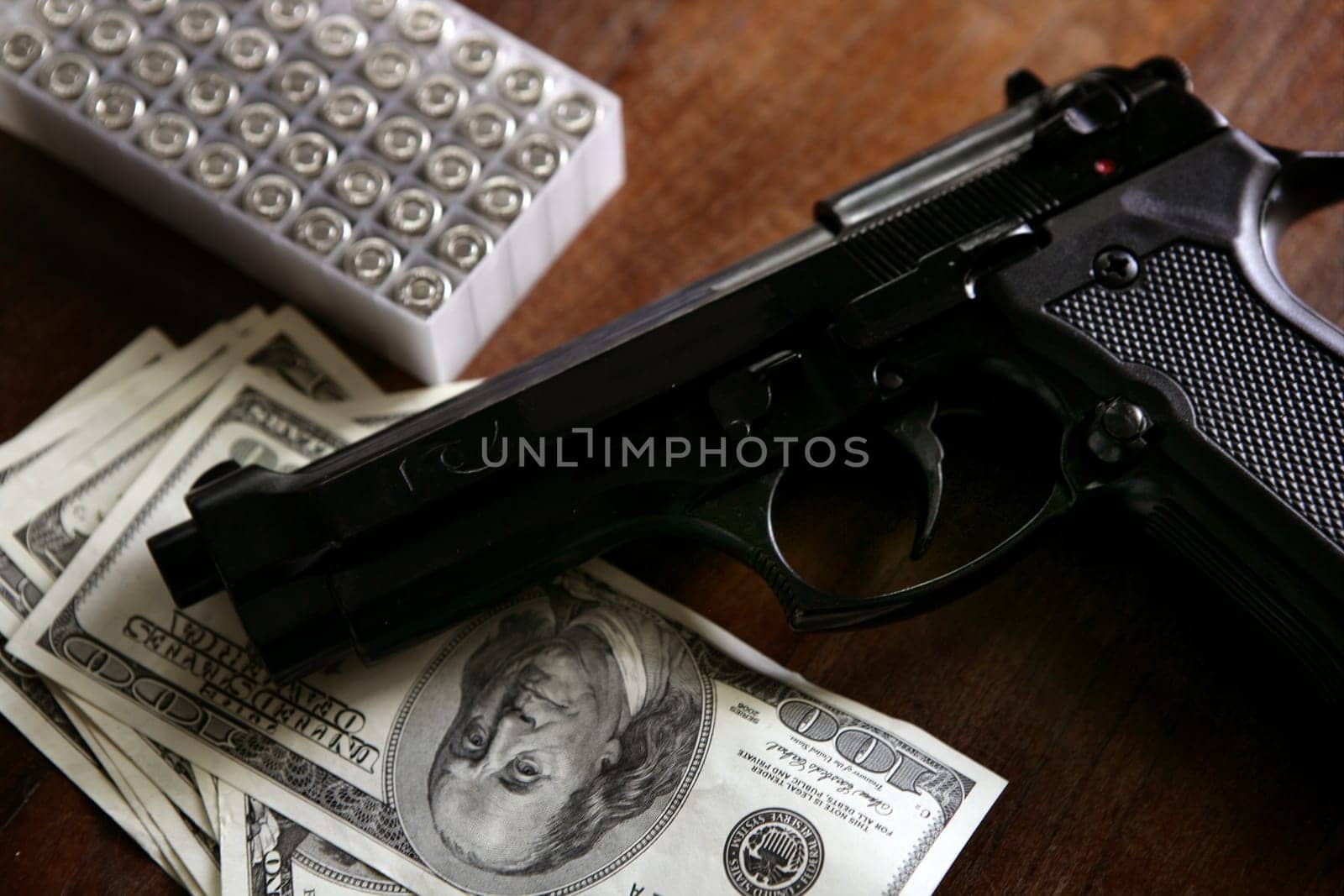 Dollar notes and gun, black pistol, mafia inspiration