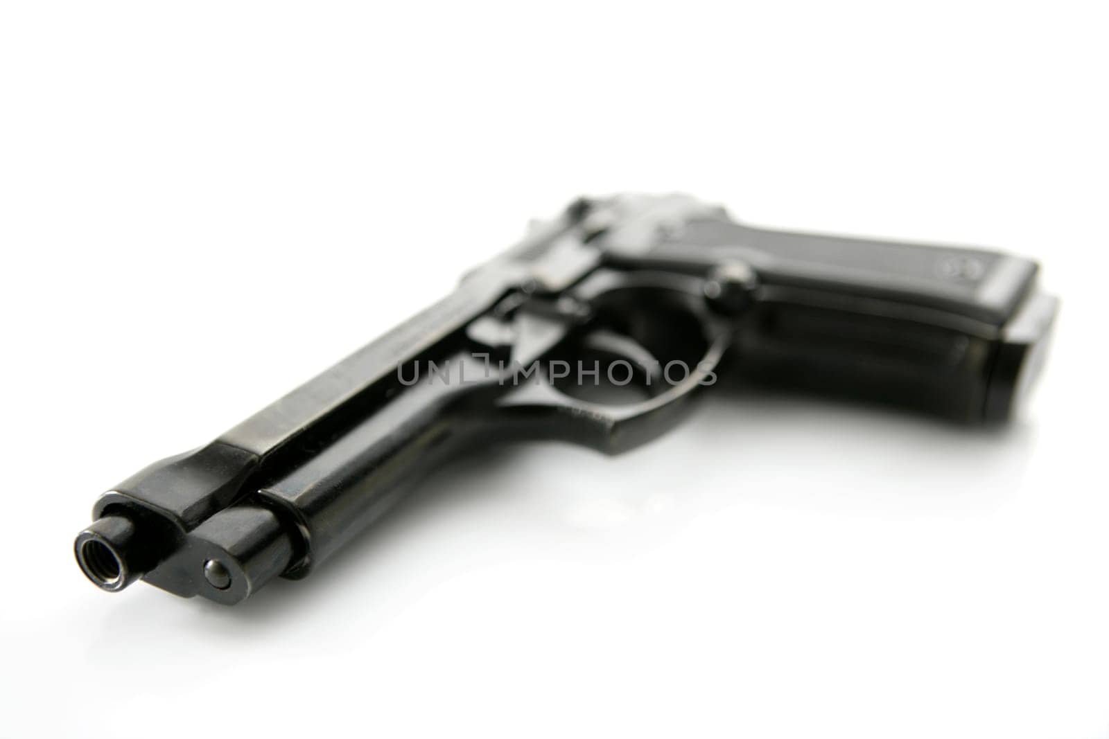 black hand gun pistol over white background, selective focus, studio shot